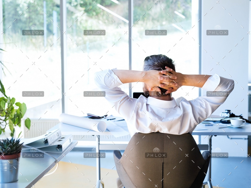 Businessman-at-the-desk-in-his-office-resting.-2